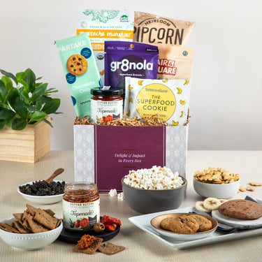 Celebrating AAPI Heritage gift basket, featuring snacks like Pipcorn, gr8nola, Partake cookies, banana bread superfood cookie, tea, and more treats